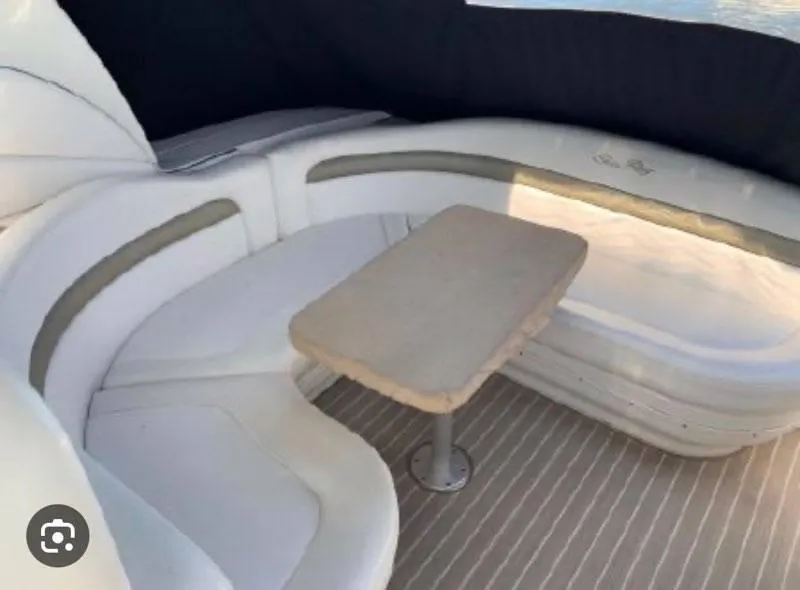 Slide: The Image of 2007 Sea Ray 320 Sundancer interior with curved seating and table. - 9