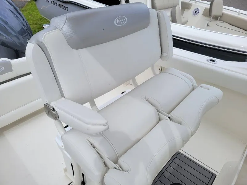 Slide: The Image of 2024 Key West 244 CC boat with white cushioned seating. - 11