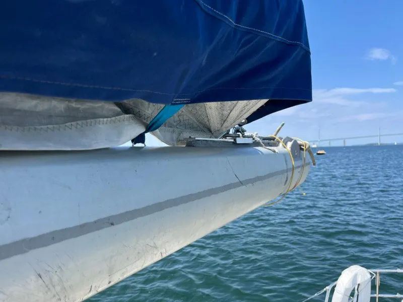 Slide: The Image of Sailboat boom with blue cover on a 1986 Nautor Swan 43, sailing on calm waters. - 10