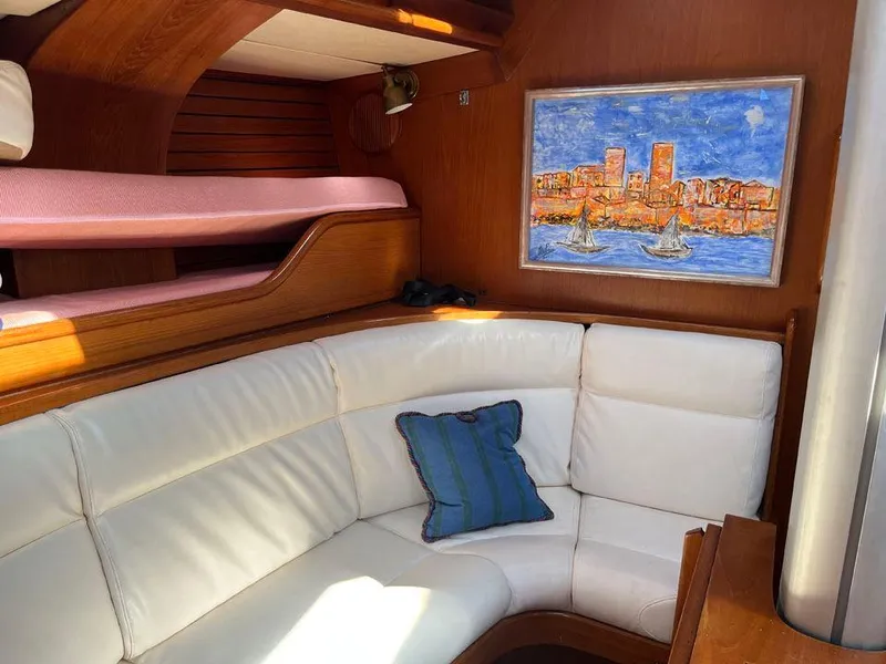 Slide: The Image of Interior of 1986 Nautor Swan 43 yacht with white seating and nautical artwork. - 20