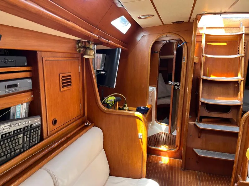 Slide: The Image of Interior of 1986 Nautor Swan 43 yacht with wooden finish and cozy seating area. - 21