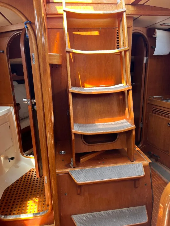 Slide: The Image of Interior of 1986 Nautor Swan 43 yacht with wooden stairs and cabin details. - 23