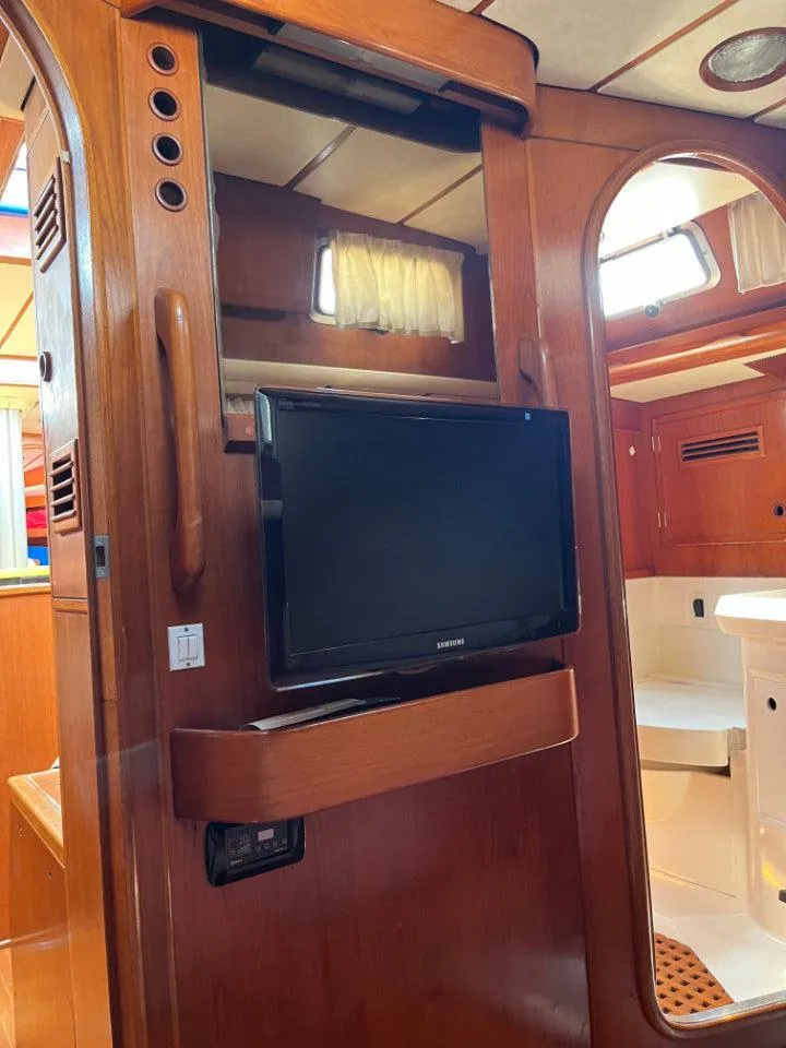 Slide: The Image of Interior of 1986 Nautor Swan 43 yacht with wooden paneling and mounted TV. - 28