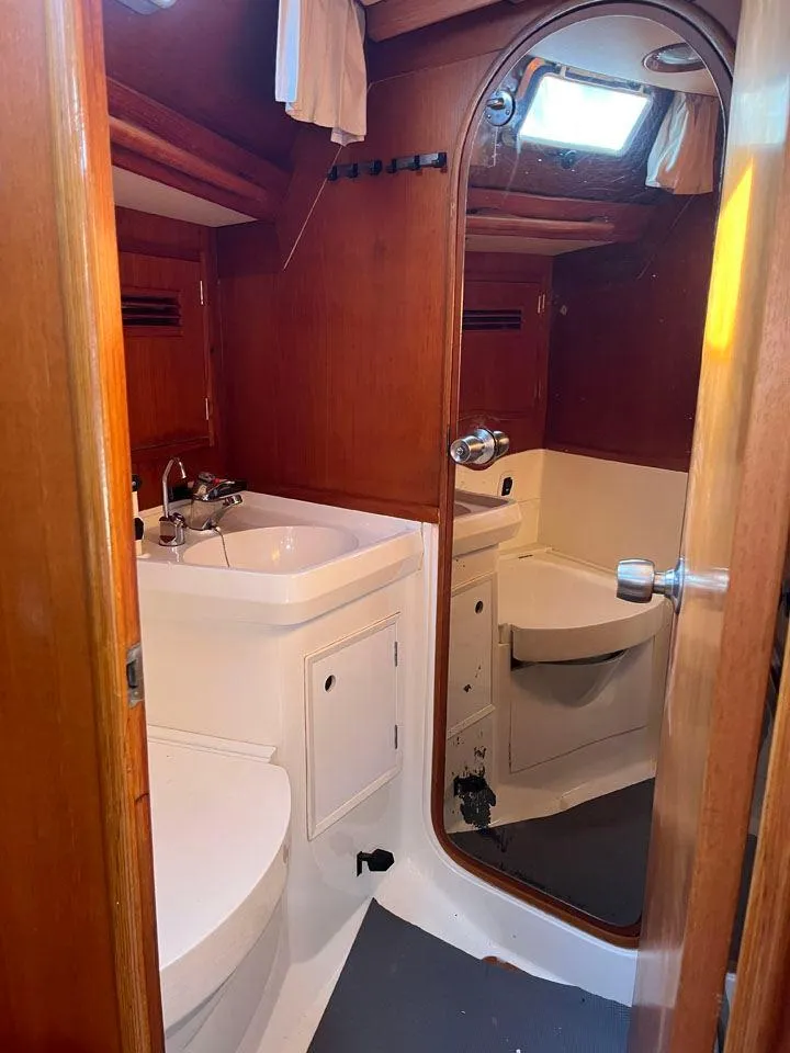 Slide: The Image of Nautor Swan 43 yacht bathroom, 1986 model, featuring wooden cabinetry and a mirror. - 29