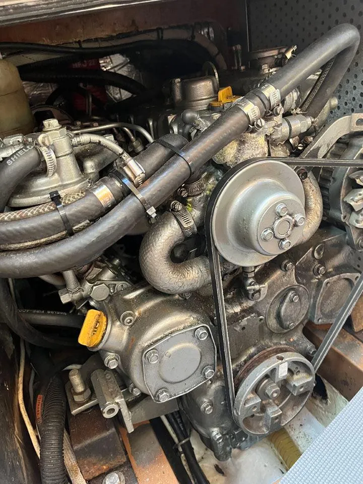 Slide: The Image of Engine of a 1986 Nautor Swan 43 sailboat, showcasing mechanical components and belts. - 30