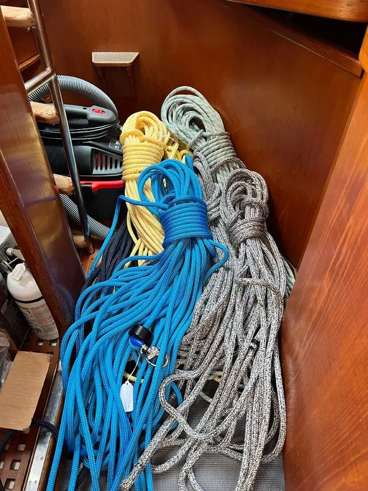 Slide: The Image of Coiled ropes in a Nautor Swan 43 yacht, 1986 model, stored neatly in a wooden compartment. - 33