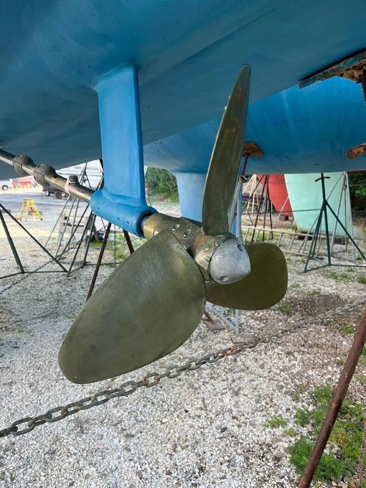 Slide: The Image of Propeller of 1986 Nautor Swan 43 sailboat on dry dock, showing hull and support stands. - 35