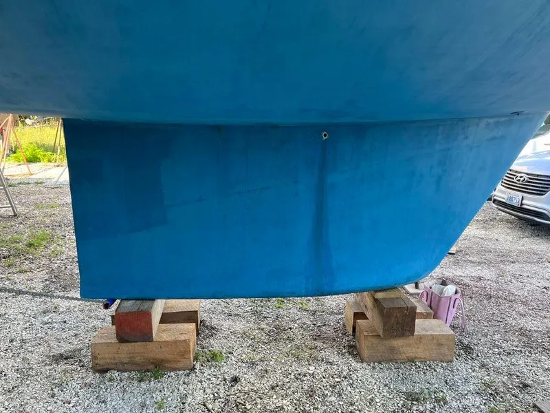 Slide: The Image of Blue hull of a 1986 Nautor Swan 43 sailboat on wooden blocks. - 36