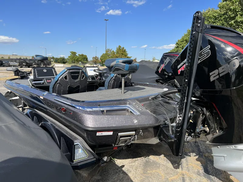 Slide: The Image of 2024 Ranger Z520R boat deck with blue and gray seating, parked on a road. - 4