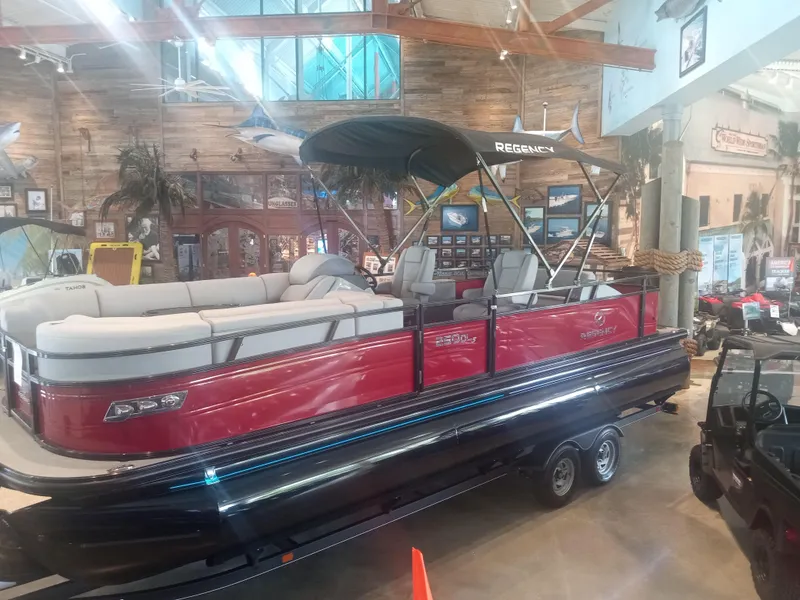 Slide: The Image of 2024 Regency 250 DL3 pontoon boat on display in showroom. - 0