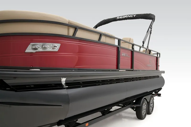 Slide: The Image of 2024 Regency 250 DL3 pontoon boat with red exterior and black trailer. - 11