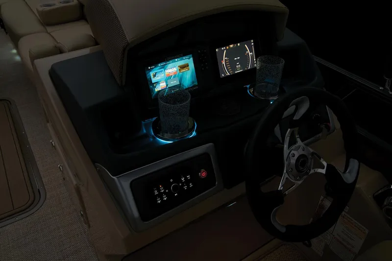 Slide: The Image of 2024 Regency 250 DL3 boat dashboard with illuminated controls and digital displays. - 49
