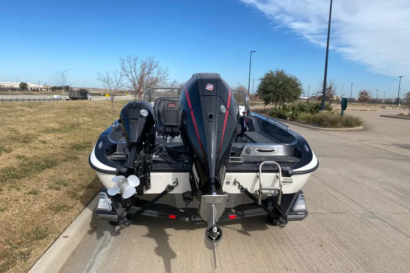 Slide: The Image of 2024 Ranger 621FS Cup-Equipped boat with powerful outboard motor, parked on concrete. - 13