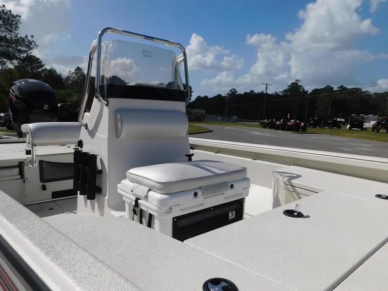 Slide: The Image of 2024 Ranger RB200 boat interior with seating and console on a sunny day. - 4