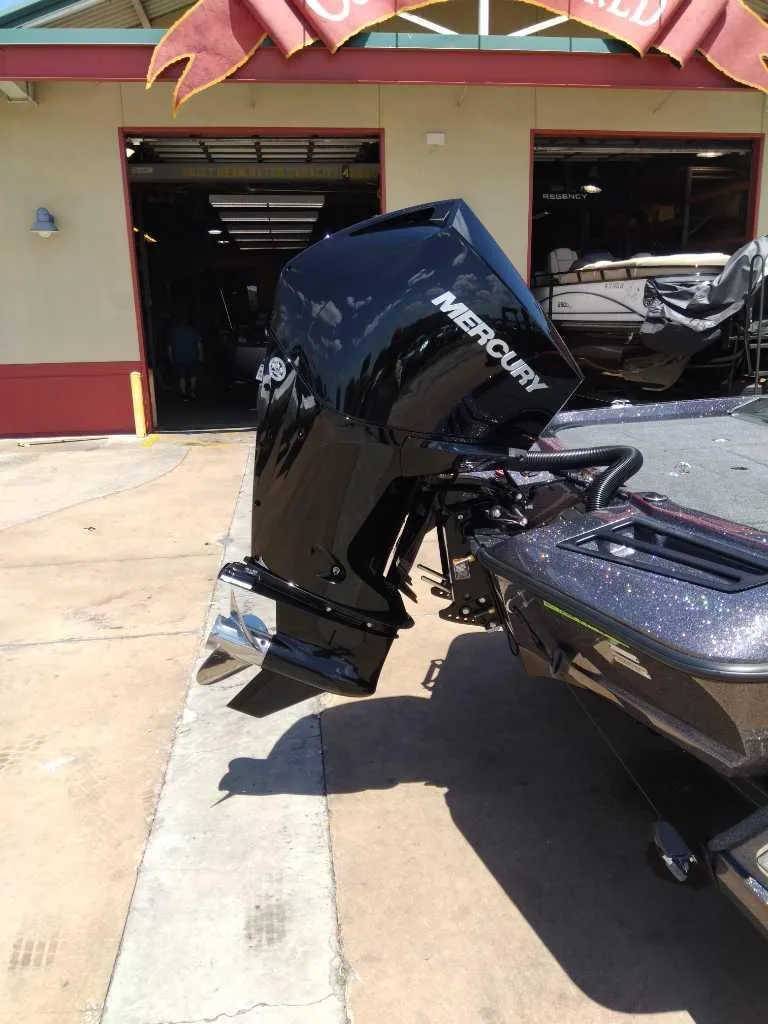 Slide: The Image of 2024 Ranger Z518 boat on trailer in showroom, featuring Lowrance equipment. - 1