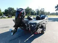 Slide: The Image of 2024 Ranger RT188 boat with outboard motor in a parking lot. - 5