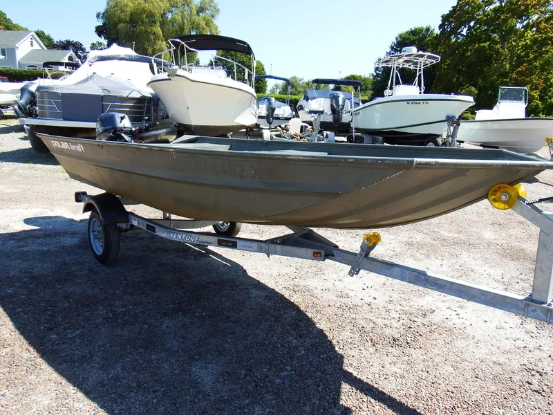 Slide: The Image of 2018 Polar Kraft Jon 1448 LW boat on a trailer in a marina. - 8