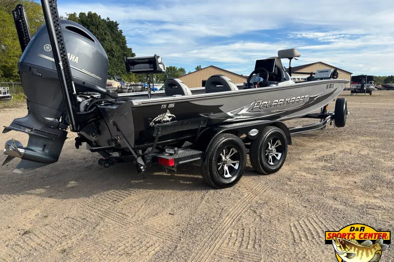 Slide: The Image of 2018 Polar Kraft TX 195 boat with Yamaha motor on a trailer, parked outdoors. - 2