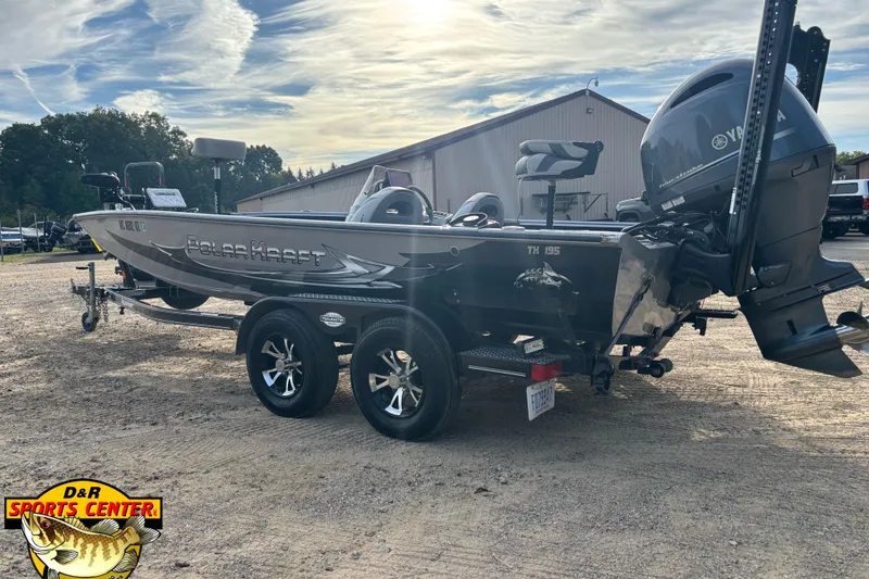 Slide: The Image of 2018 Polar Kraft TX 195 boat on trailer, parked outdoors under a partly cloudy sky. - 4