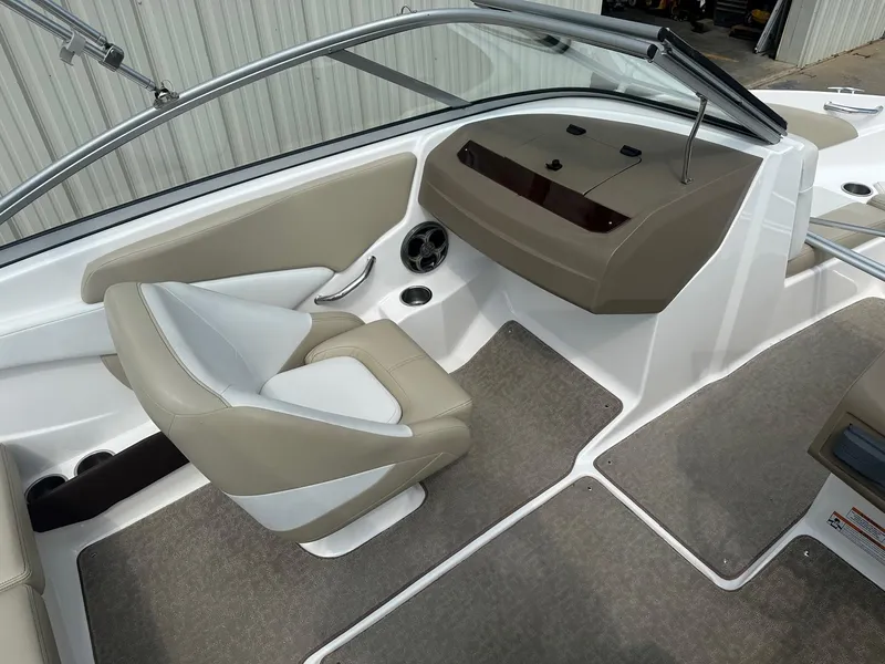 Slide: The Image of 2015 Regal 1900 boat interior with beige and white seating. - 10