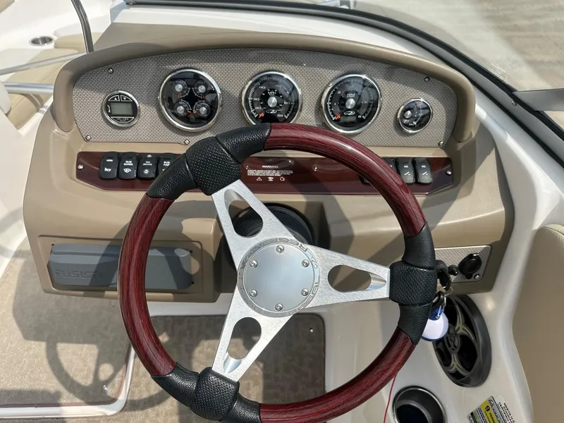 Slide: The Image of Steering wheel and dashboard of a 2015 Regal 1900 boat. - 11