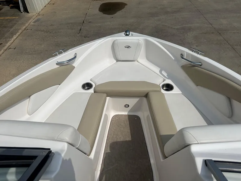 Slide: The Image of 2015 Regal 1900 boat interior with beige and white seating. - 13
