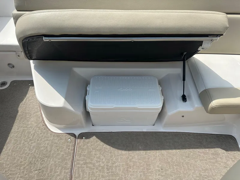Slide: The Image of 2015 Regal 1900 boat interior with storage compartment and cooler. - 17