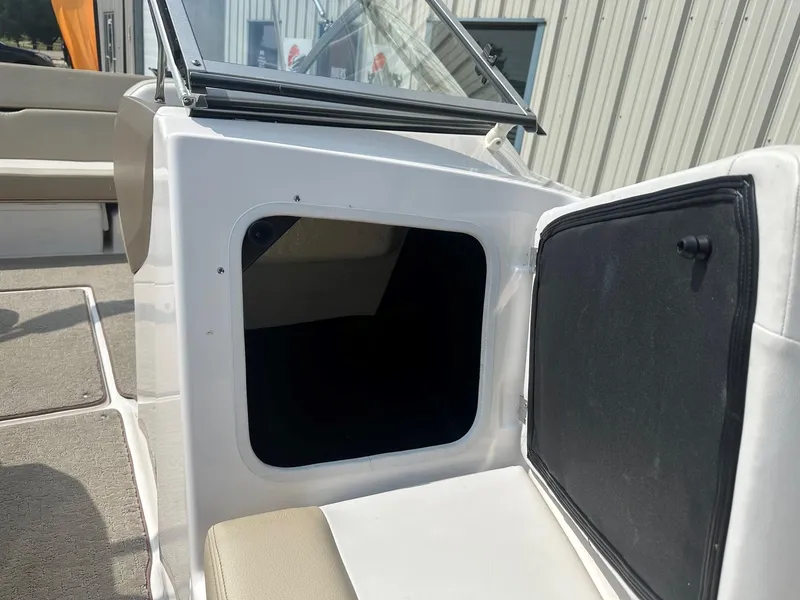 Slide: The Image of 2015 Regal 1900 boat interior storage compartment and seating area. - 20