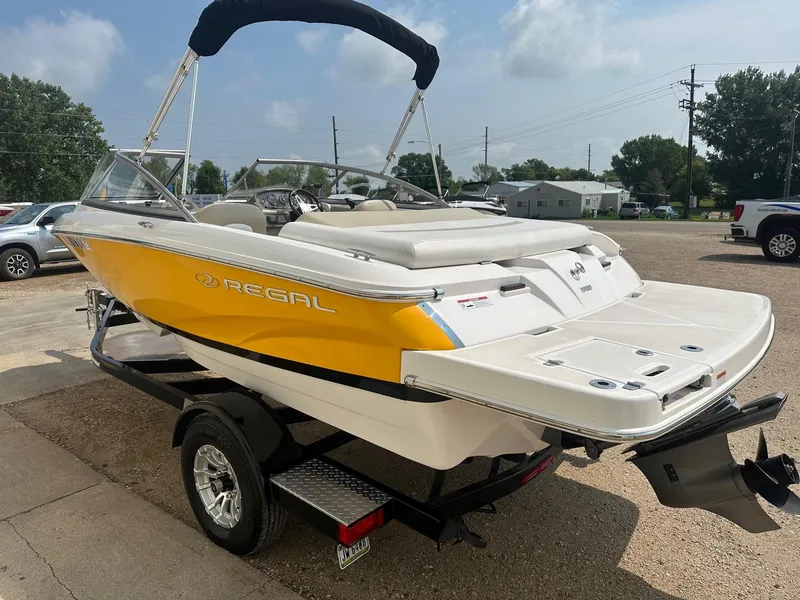 Slide: The Image of 2015 Regal 1900 boat with yellow and white exterior on a trailer. - 4