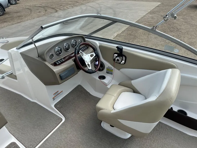 Slide: The Image of 2015 Regal 1900 boat interior, featuring a modern helm and comfortable seating. - 9