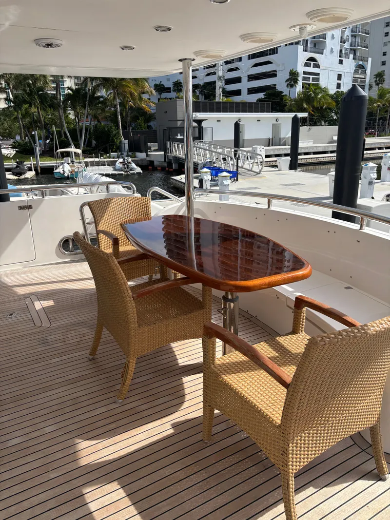 Slide: The Image of Outdoor seating on a 2009 Horizon Vision 74 yacht with wicker chairs and wooden table. - 15
