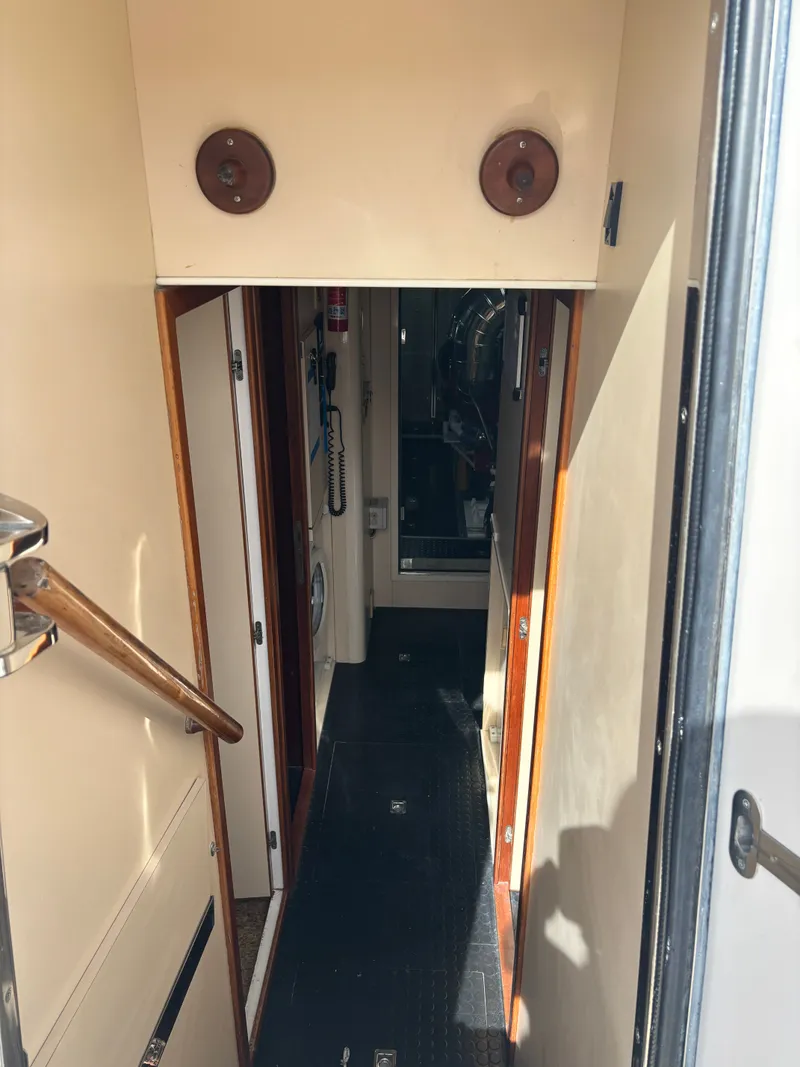 Slide: The Image of Narrow hallway inside 2009 Horizon Vision 74 yacht with wooden accents and visible equipment. - 16