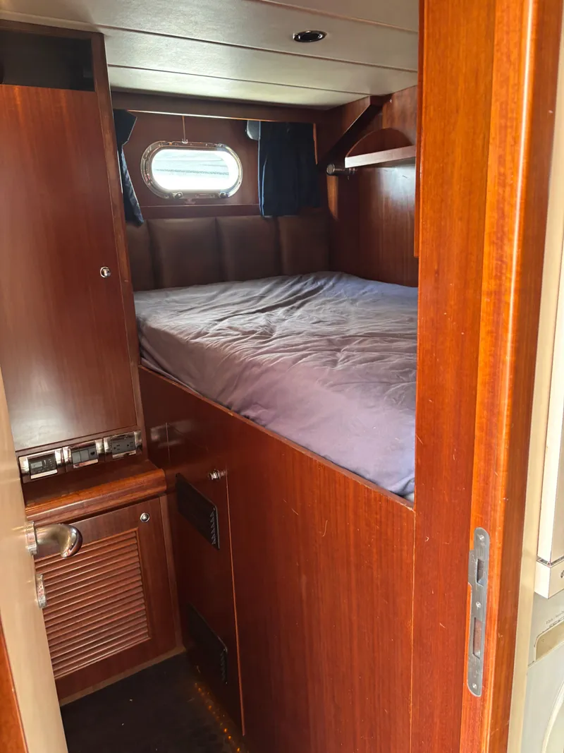 Slide: The Image of Cozy cabin interior of 2009 Horizon Vision 74 yacht with wooden furnishings and bed. - 18