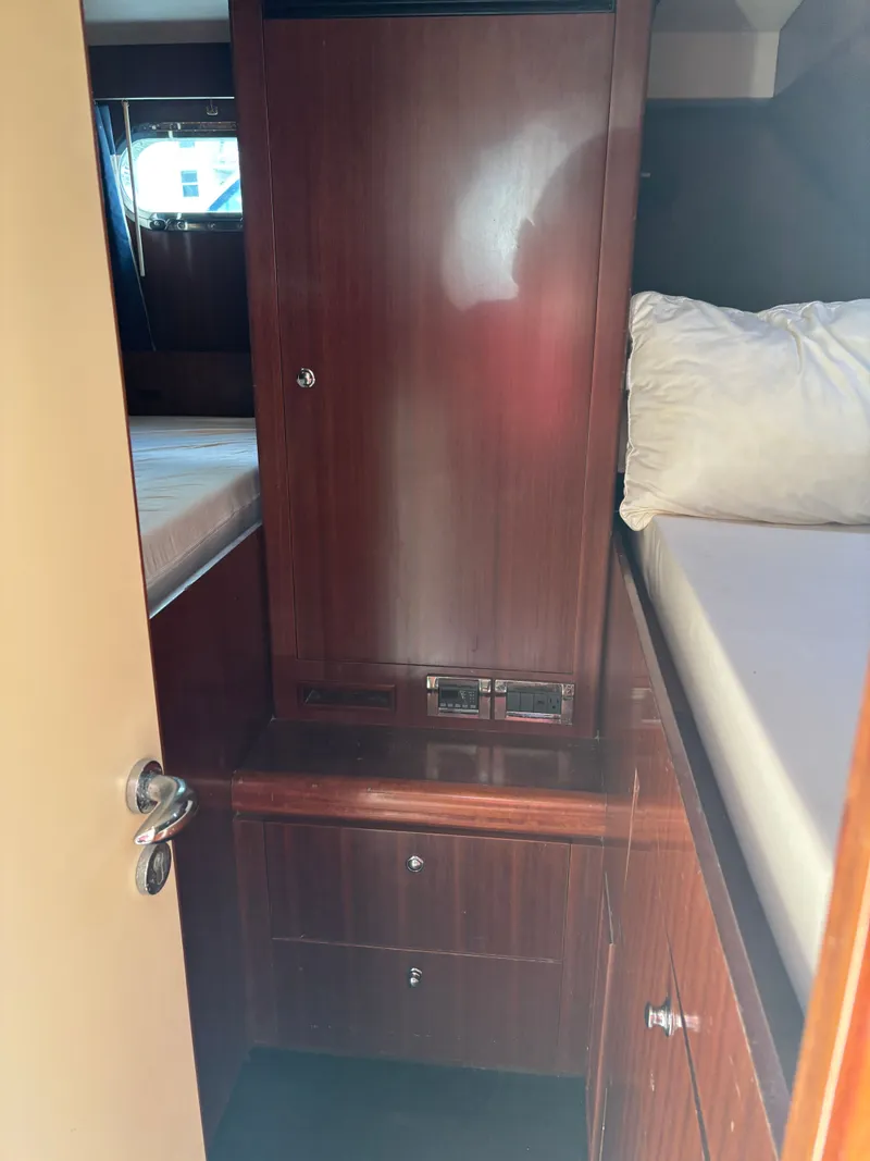 Slide: The Image of Interior cabin of 2009 Horizon Vision 74 yacht with wooden cabinetry and bedding. - 19