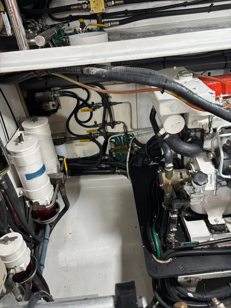Slide: The Image of Engine room of a 2009 Horizon Vision 74 yacht, showcasing mechanical components and piping. - 29