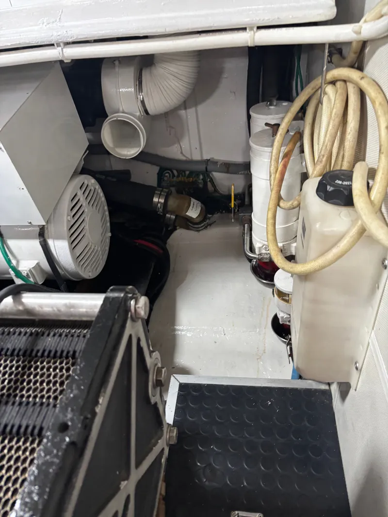 Slide: The Image of Engine room of 2009 Horizon Vision 74 yacht, featuring mechanical components and hoses. - 30