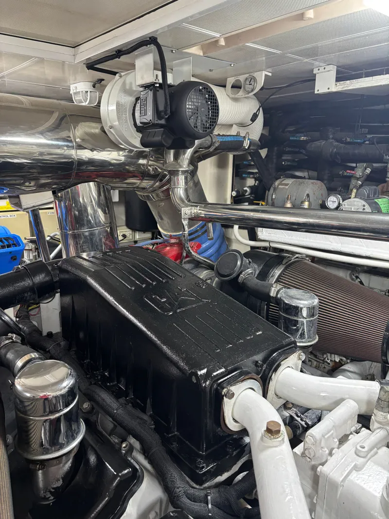 Slide: The Image of Engine room of 2009 Horizon Vision 74 yacht, showcasing mechanical components and piping. - 32