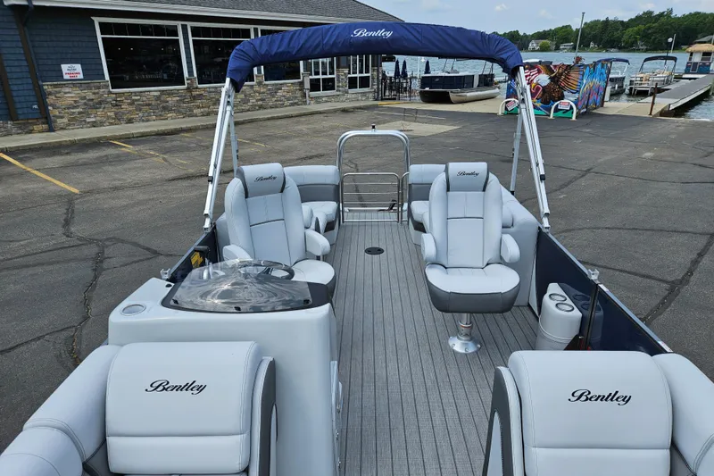 Slide: The Image of 2024 Bentley Pontoons Elite 220 Admiral interior with luxurious seating and canopy. - 14