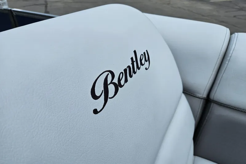 Slide: The Image of 2024 Bentley Pontoons Elite 220 Admiral white leather seating with Bentley logo. - 19