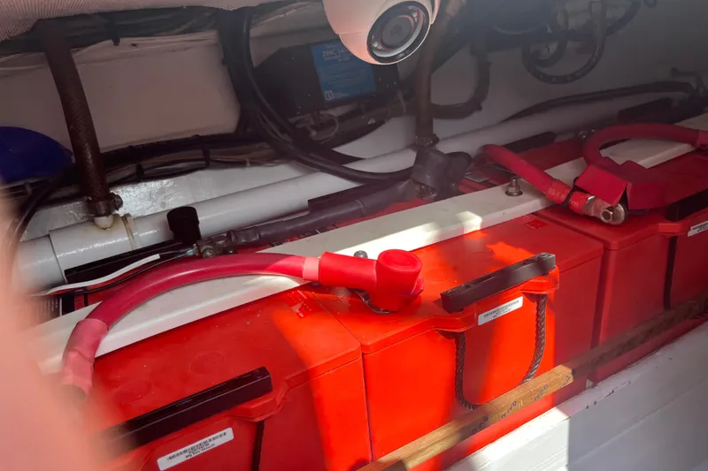 Slide: The Image of 1985 Rybovich Walkaround boat battery compartment with red battery cables. - 17