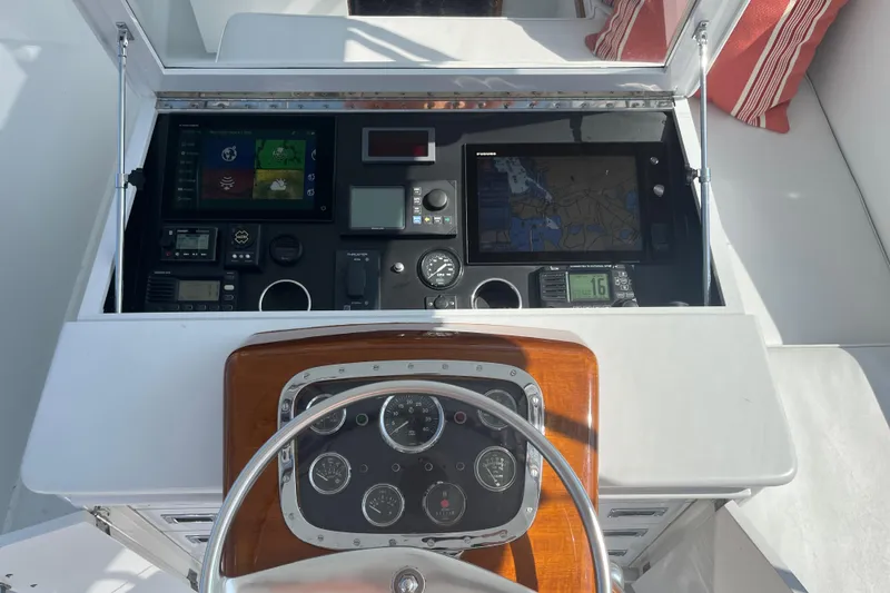 Slide: The Image of 1985 Rybovich Walkaround boat dashboard with navigation and control instruments. - 21