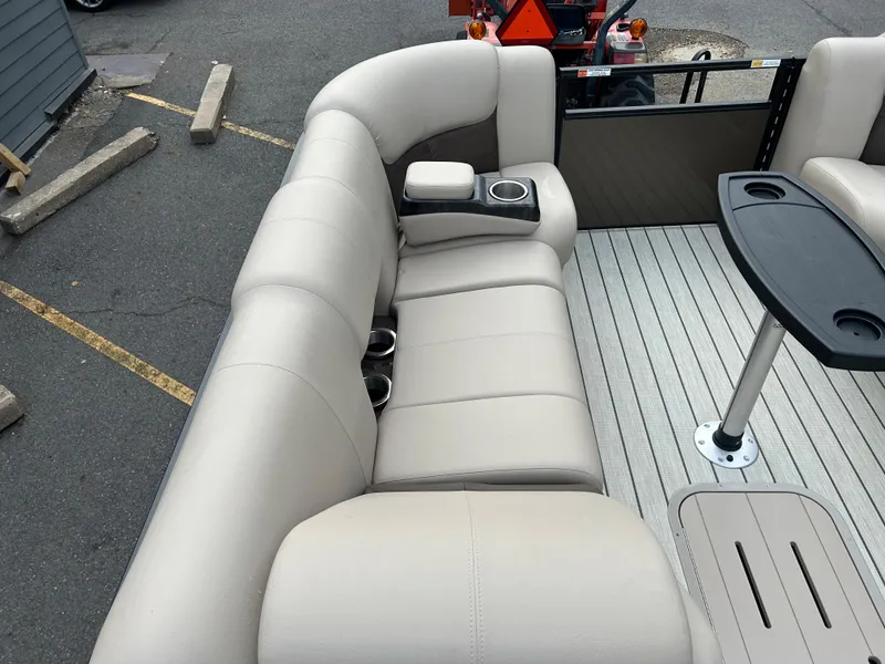Slide: The Image of 2023 SunCatcher Fusion 324RC boat interior with beige seating and cup holders. - 10