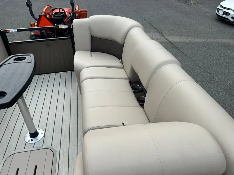 Slide: The Image of 2023 SunCatcher Fusion 324RC boat with beige seating and cup holders. - 11