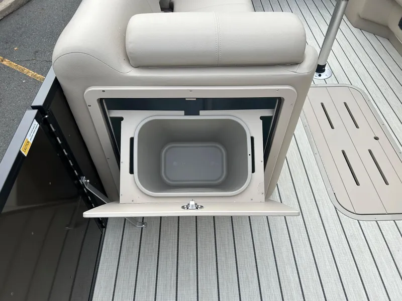Slide: The Image of 2023 SunCatcher Fusion 324RC boat storage compartment with open lid. - 13