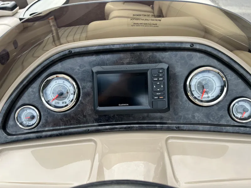 Slide: The Image of 2023 SunCatcher Fusion 324RC dashboard with gauges and Garmin display. - 16