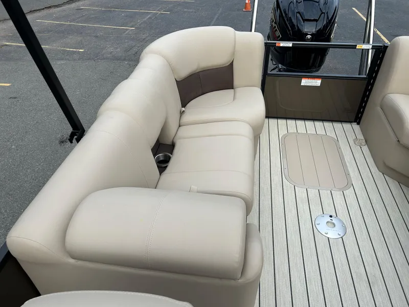 Slide: The Image of 2023 SunCatcher Fusion 324RC boat interior with beige seating and deck. - 17