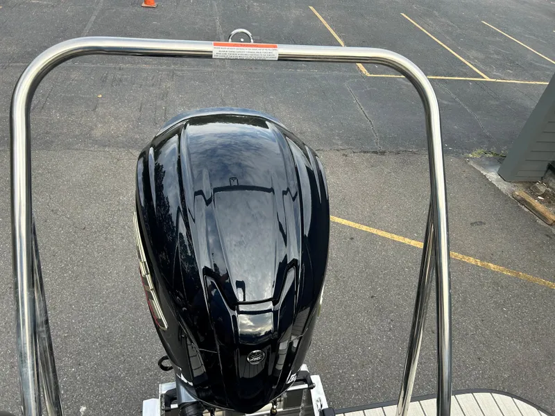 Slide: The Image of 2023 SunCatcher Fusion 324RC outboard motor on a boat. - 22