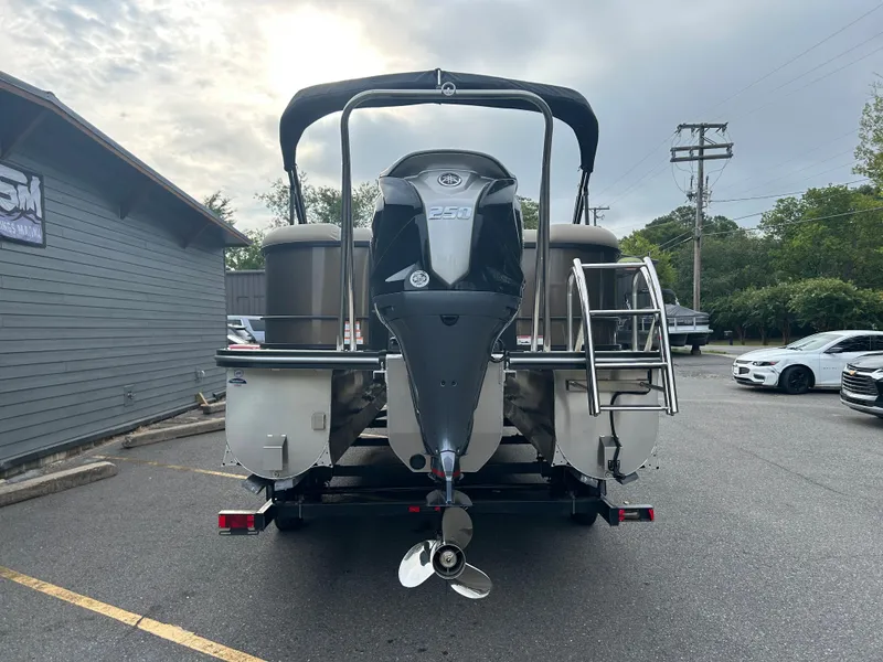 Slide: The Image of 2023 SunCatcher Fusion 324RC pontoon boat with outboard motor, rear view in parking lot. - 6