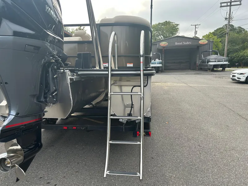 Slide: The Image of 2023 SunCatcher Fusion 324RC pontoon boat with ladder and outboard motor. - 7