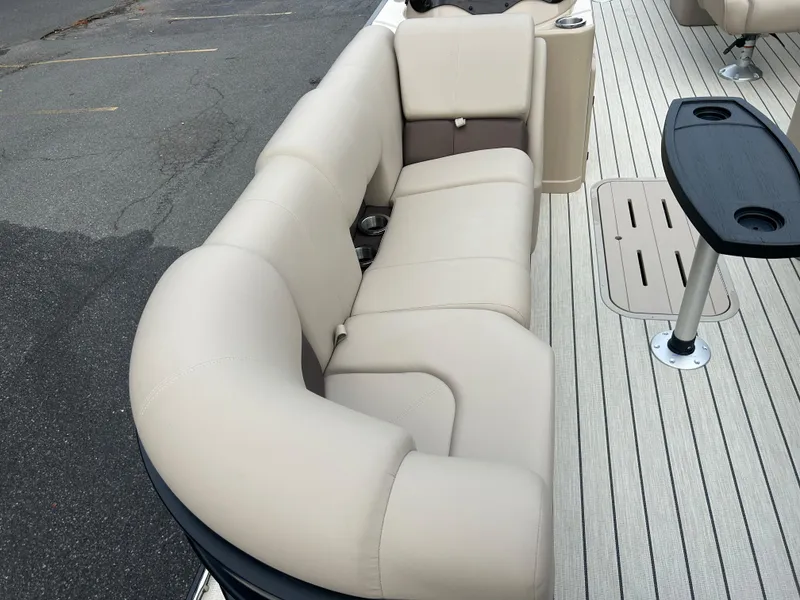 Slide: The Image of 2023 SunCatcher Fusion 324RC boat with beige seating and deck table. - 8